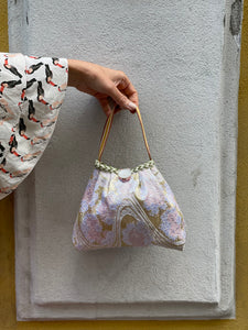 Borsetta fantasia rosa e oro con patella bianca e grigia